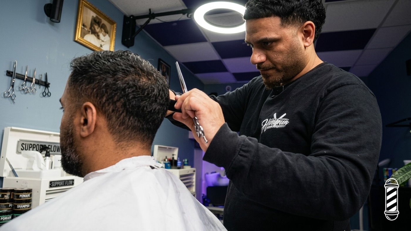 Hamoudi cutting hair at Homegrown Barbers